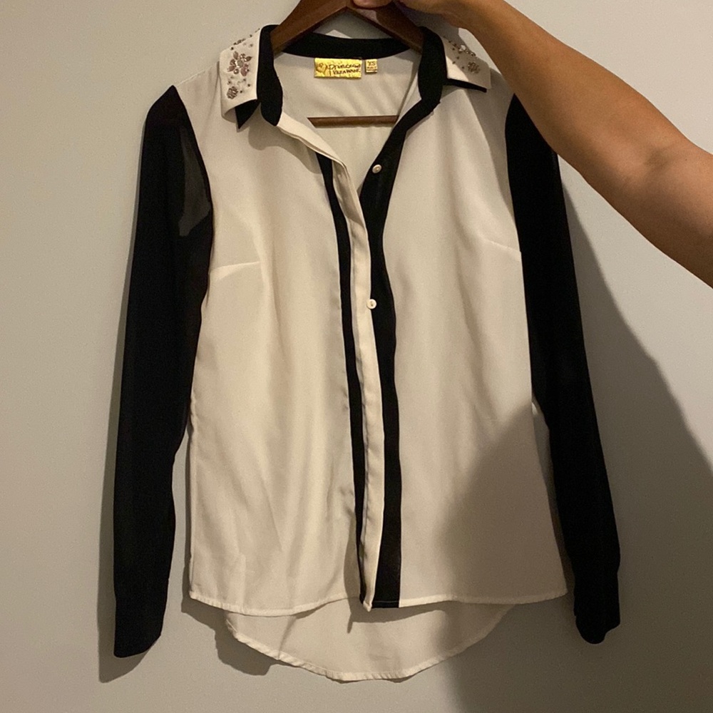 Woman’s black and white sheer blouse.